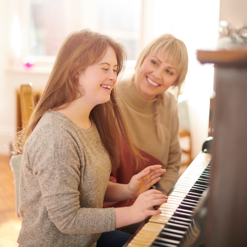 woman at a piano with her music teacher