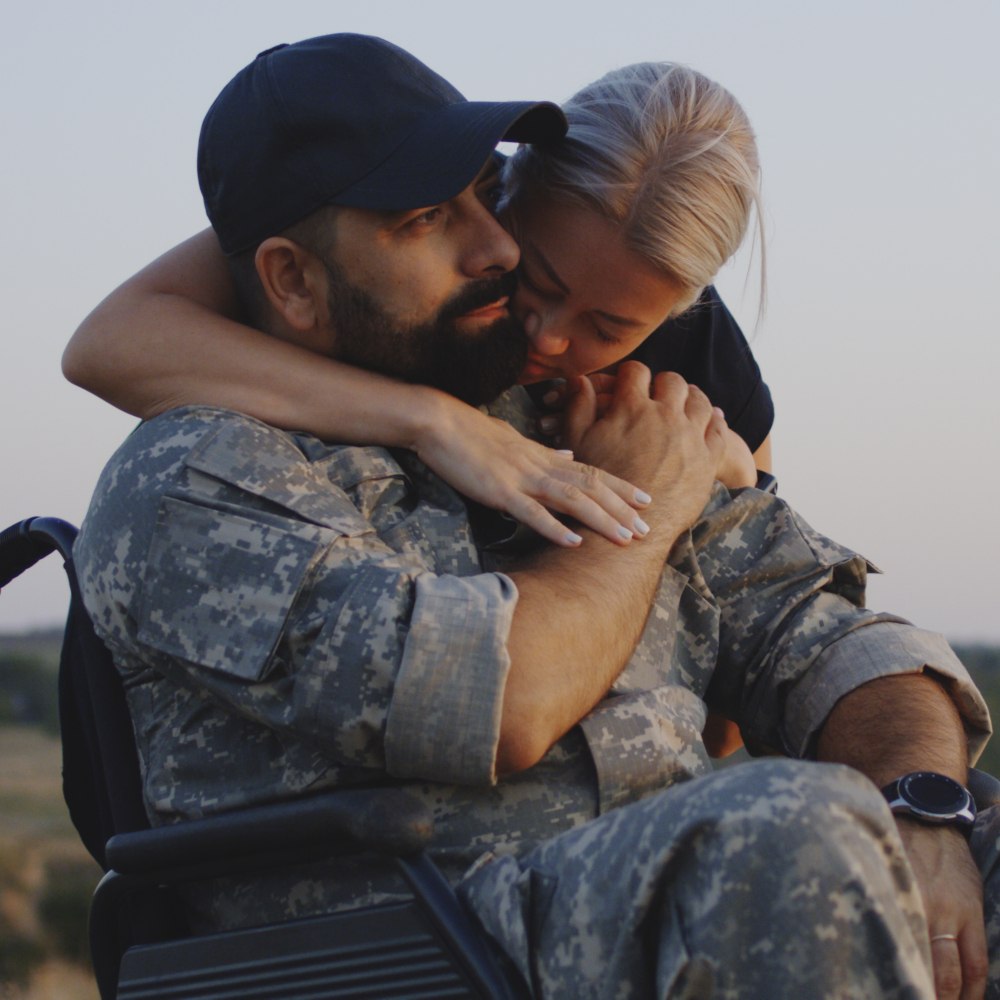 veteran soldier in a wheelchair with a loved one