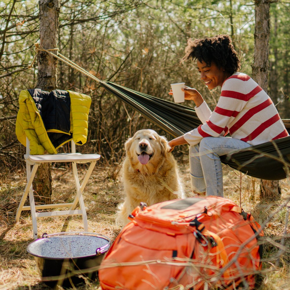 woman camping with a dog