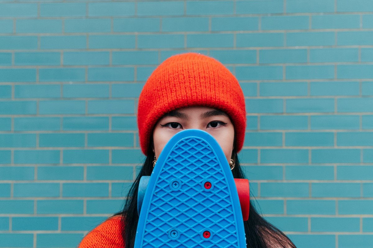 woman holding a skateboard