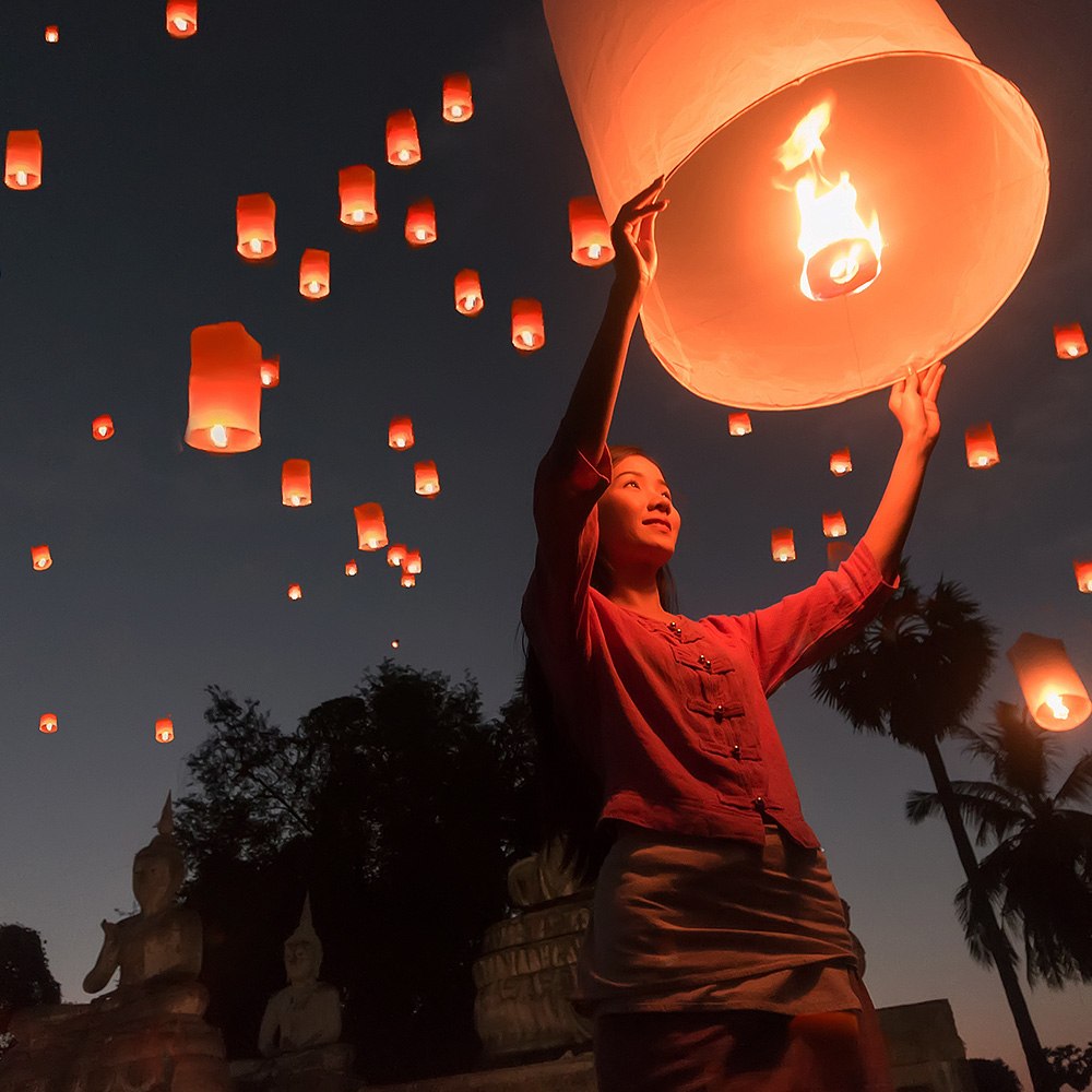 A woman flying hot air lanterns