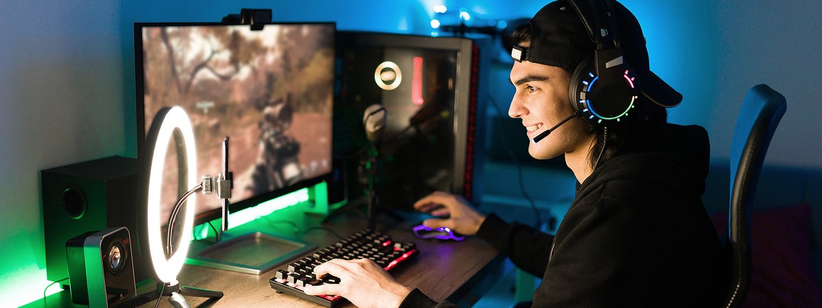 A young man playing video games while streaming online to followers